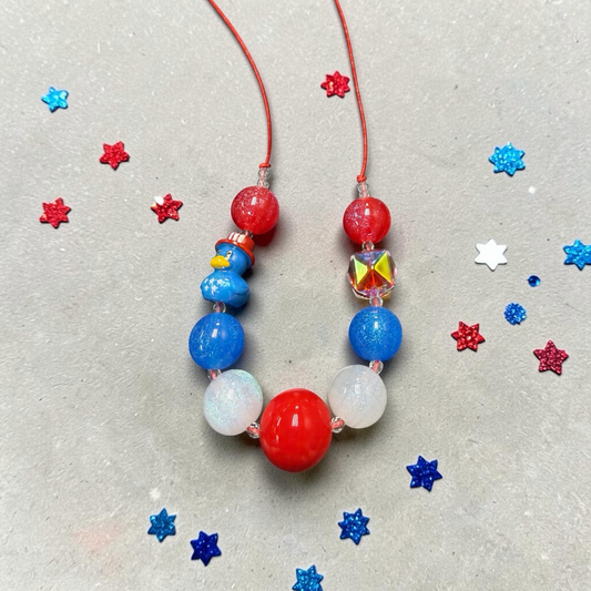 Mloved Designs patriotic beaded necklace with red, white, and blue glitter beads and a cute duck charm.